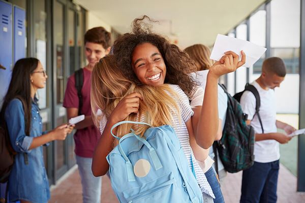 two high school girls celebrating award in school two high school girls celebrating award in school image